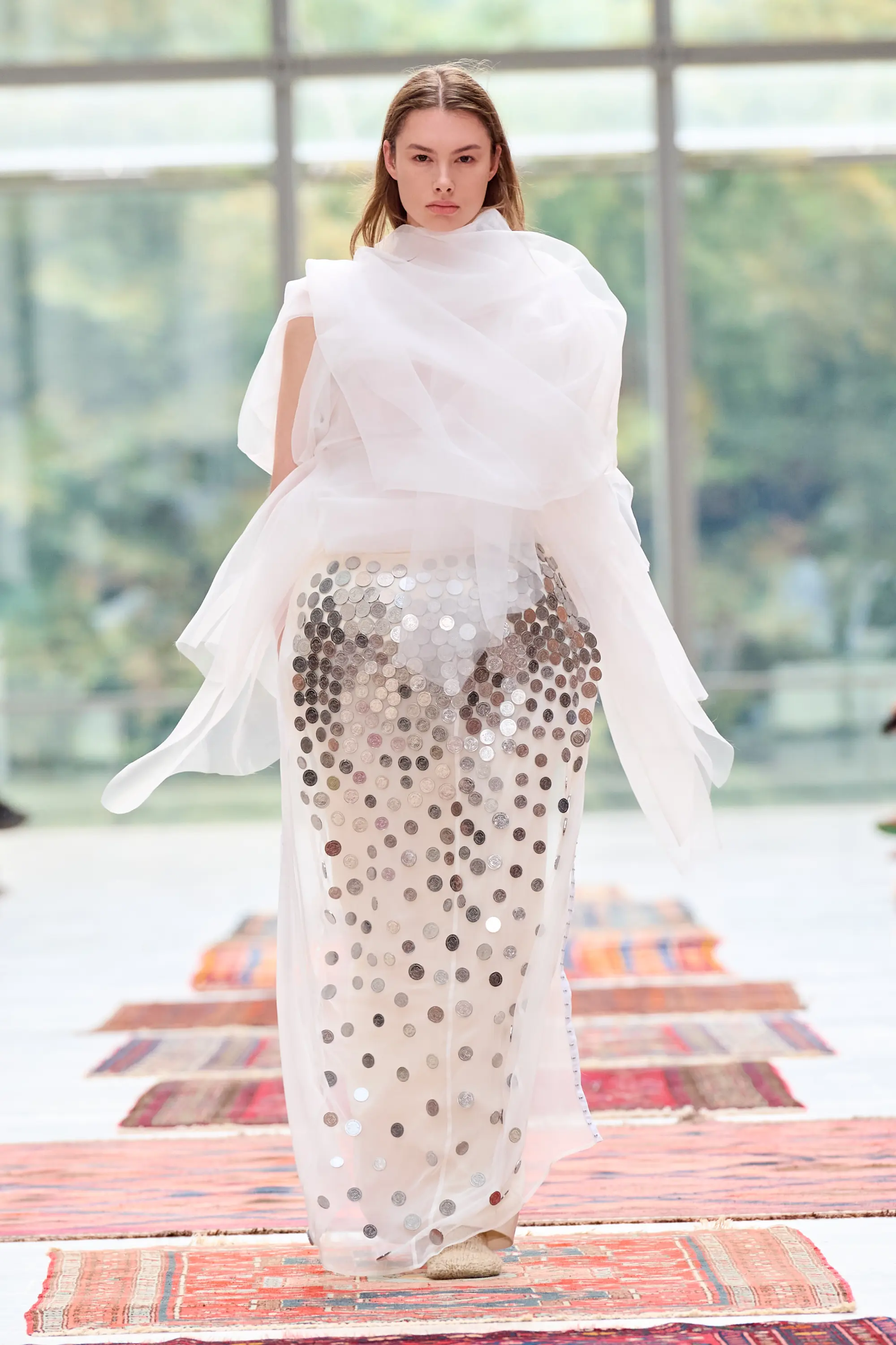 A white translucent Institution look embellished with Georgian tetri coins